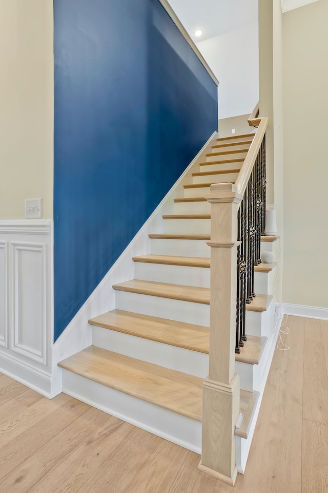 stairway with hardwood / wood-style flooring