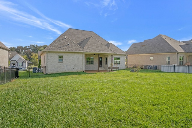 rear view of property with a lawn and a patio area