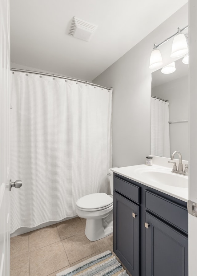 bathroom with vanity, toilet, and tile patterned floors