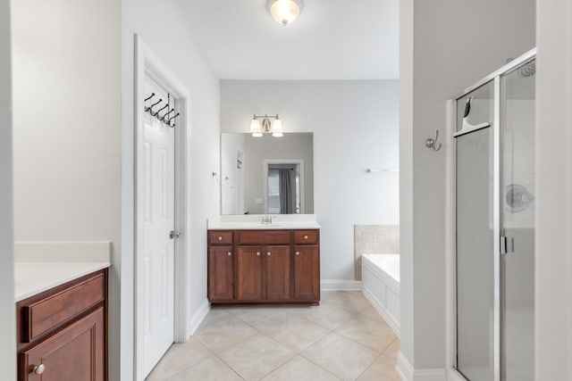 bathroom featuring tile patterned floors, independent shower and bath, and vanity