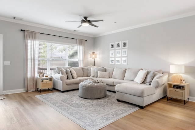 living room with ceiling fan, light wood-type flooring, and ornamental molding