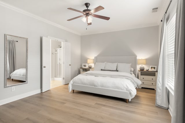 bedroom featuring light hardwood / wood-style flooring, ensuite bath, ceiling fan, and ornamental molding