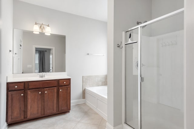 bathroom featuring independent shower and bath, vanity, and tile patterned floors