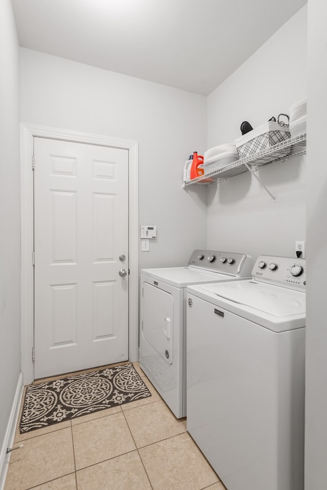 laundry area featuring light tile patterned flooring and washer and dryer