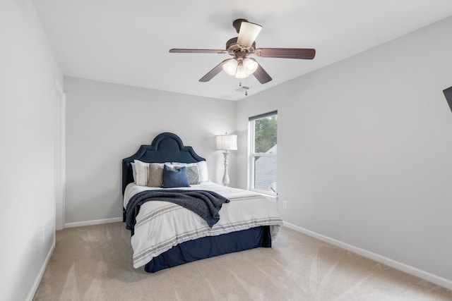 bedroom with light carpet and ceiling fan