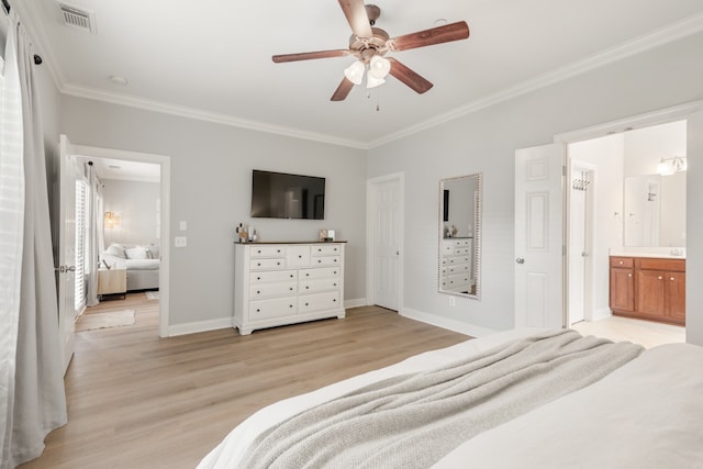 bedroom featuring light wood-type flooring, crown molding, ceiling fan, and ensuite bathroom