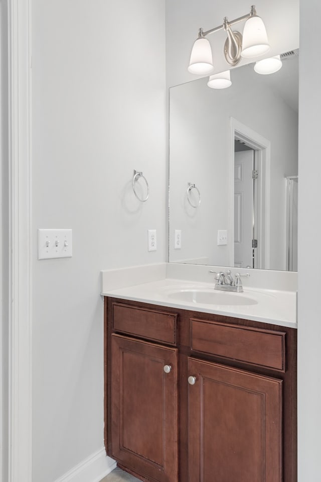 bathroom with vanity and a notable chandelier