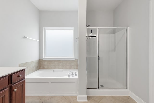 bathroom featuring vanity, plus walk in shower, and tile patterned flooring