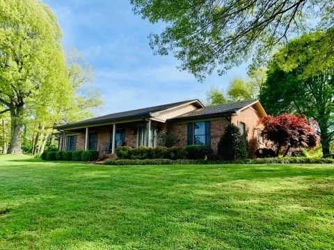 ranch-style home with a front lawn