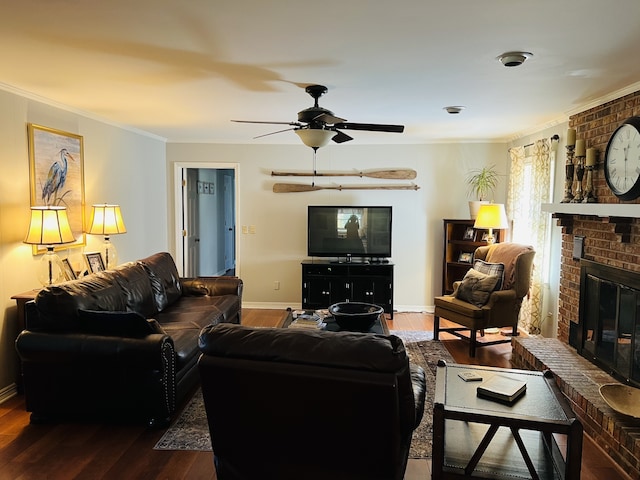 living room featuring a fireplace, dark hardwood / wood-style floors, crown molding, and ceiling fan