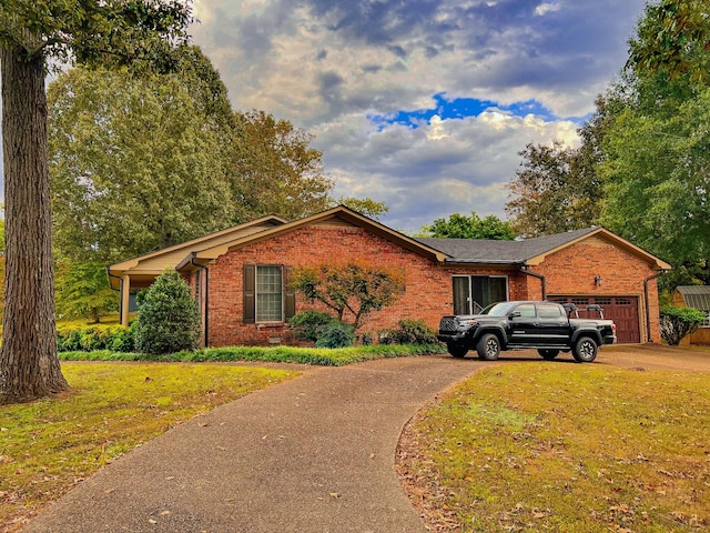 single story home with a front yard and a garage