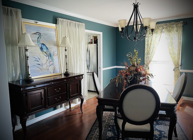 dining area with wood-type flooring, crown molding, and a notable chandelier