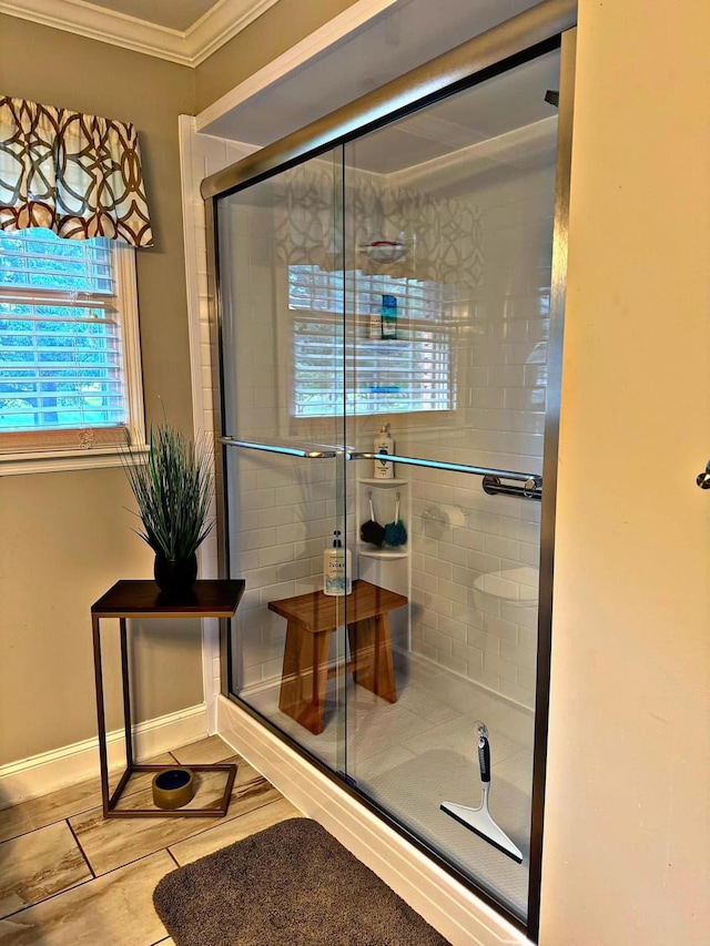 bathroom with ornamental molding and walk in shower