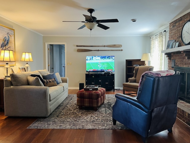 living room with a brick fireplace, crown molding, dark hardwood / wood-style flooring, and ceiling fan