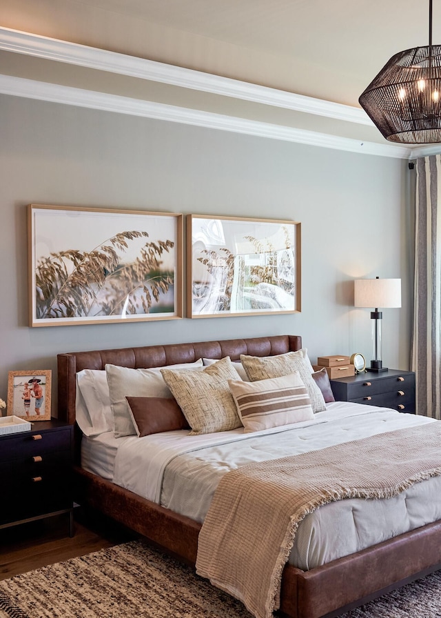 bedroom with hardwood / wood-style floors and crown molding