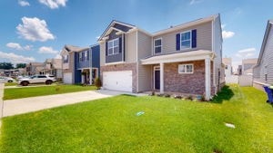 view of front facade featuring a front yard and a garage