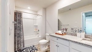 full bathroom with shower / tub combo, vanity, and toilet