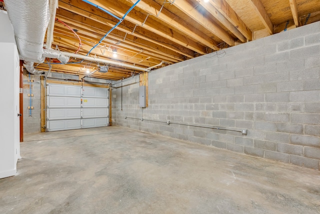 garage with a garage door opener and electric panel