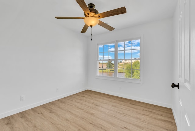 empty room featuring light wood-type flooring and ceiling fan