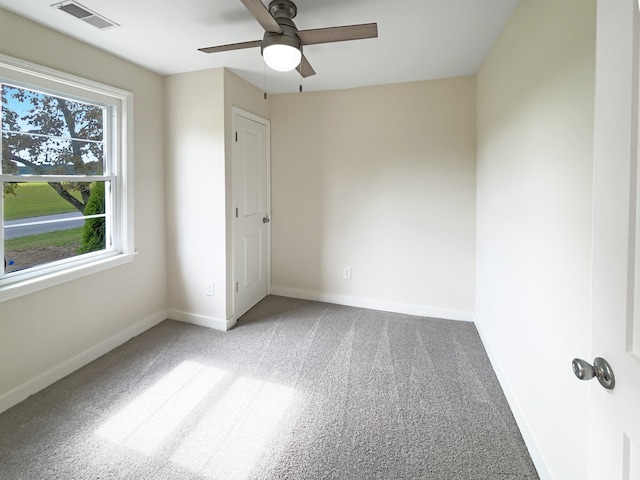 spare room with light carpet and ceiling fan