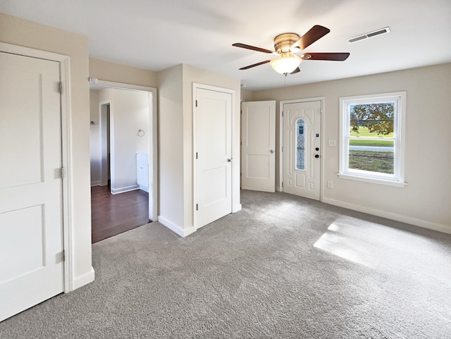 entryway featuring ceiling fan and carpet flooring