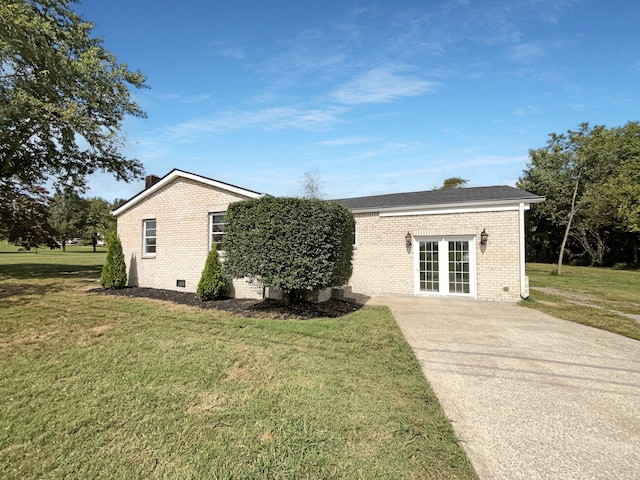 view of front facade featuring a front lawn and french doors