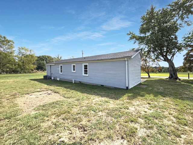 rear view of house featuring a yard