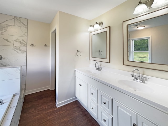 bathroom with vanity, hardwood / wood-style floors, and separate shower and tub