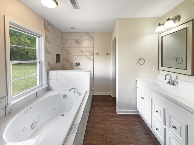 bathroom with separate shower and tub, vanity, and hardwood / wood-style floors