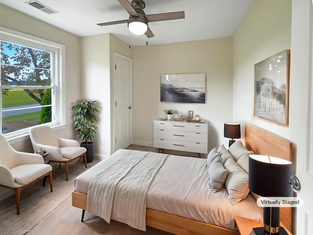 bedroom with ceiling fan and light wood-type flooring