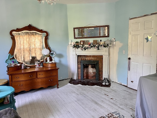 sitting room with light wood-type flooring and a fireplace