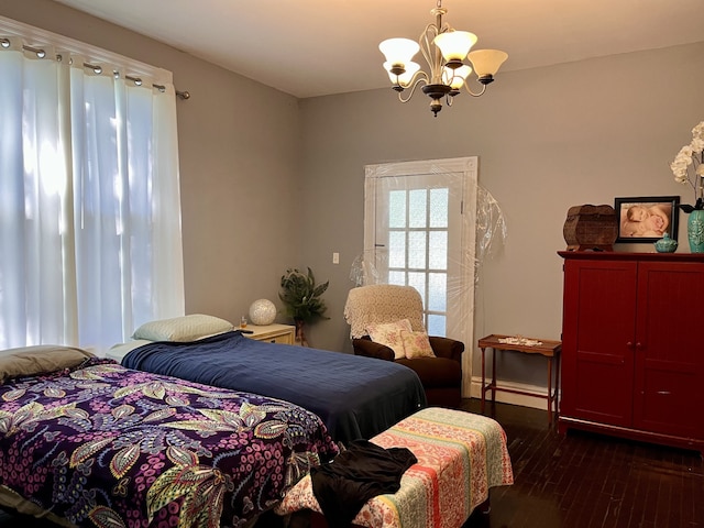 bedroom with dark wood-type flooring and a chandelier