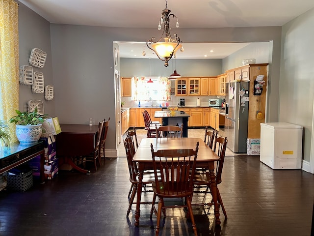 dining room with sink and dark hardwood / wood-style flooring