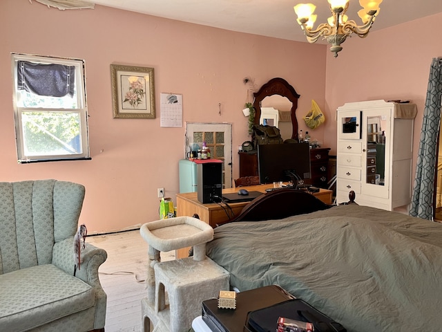 bedroom with an inviting chandelier and hardwood / wood-style floors