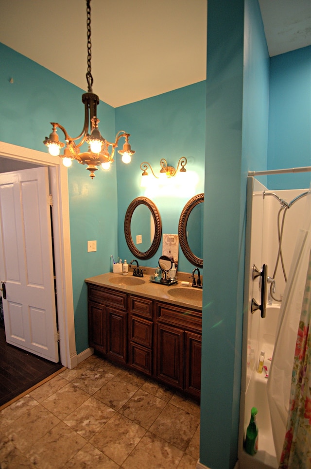 bathroom with wood-type flooring, vanity, a chandelier, and curtained shower