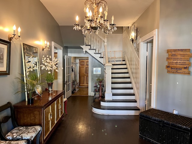 stairs featuring wood-type flooring and lofted ceiling