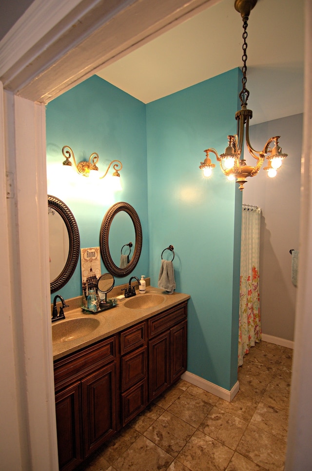 bathroom with vanity, a chandelier, and curtained shower