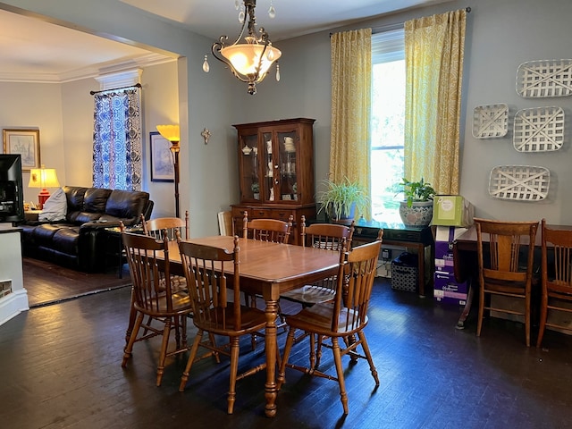 dining space with crown molding and dark hardwood / wood-style floors