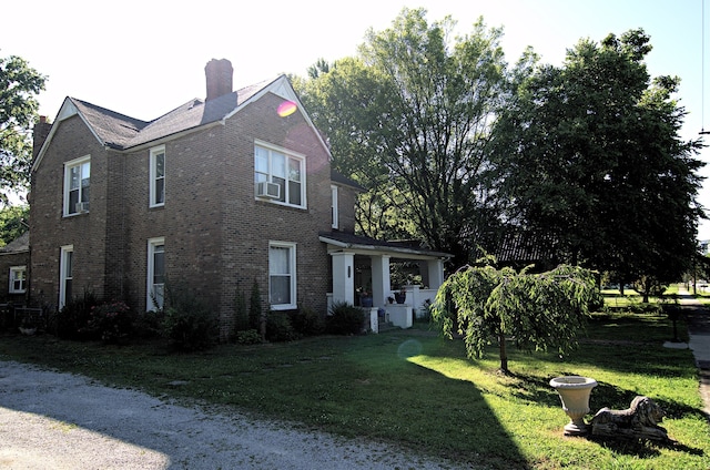 view of side of home with a yard