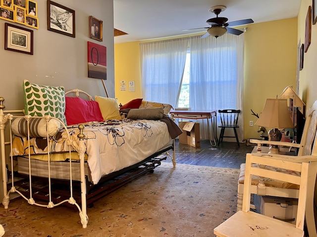 bedroom with ceiling fan and dark hardwood / wood-style floors