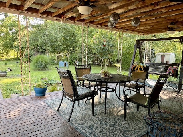 view of patio / terrace featuring a storage shed, ceiling fan, and a wooden deck