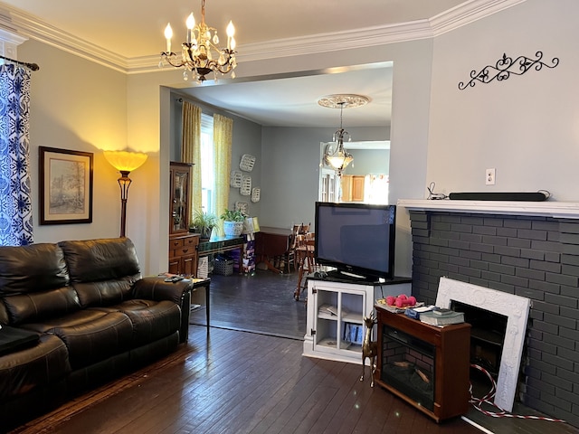 living room with a brick fireplace, ornamental molding, and dark hardwood / wood-style flooring