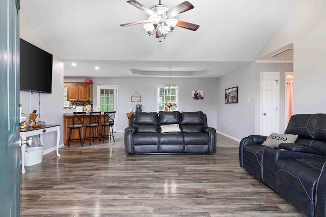 living room with ceiling fan, lofted ceiling, and dark wood-type flooring