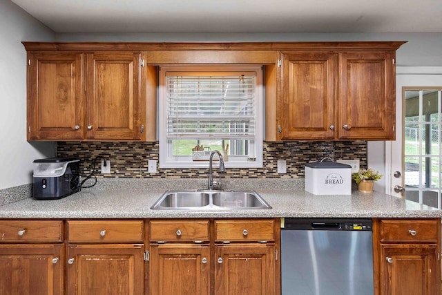 kitchen with stainless steel dishwasher, sink, tasteful backsplash, and plenty of natural light