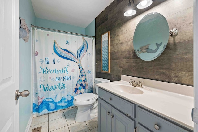 bathroom with walk in shower, vanity, toilet, and tile patterned floors