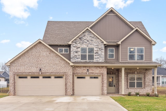 view of front of property featuring a garage and a front lawn