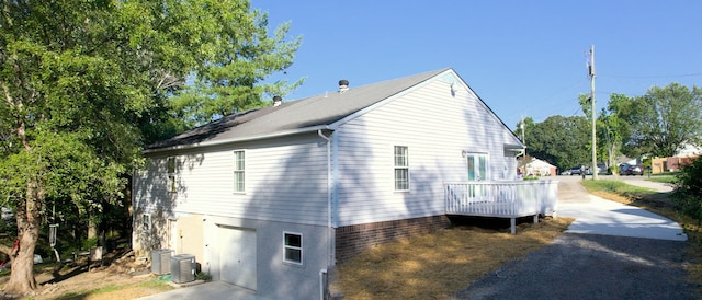 view of side of home featuring a deck and central air condition unit