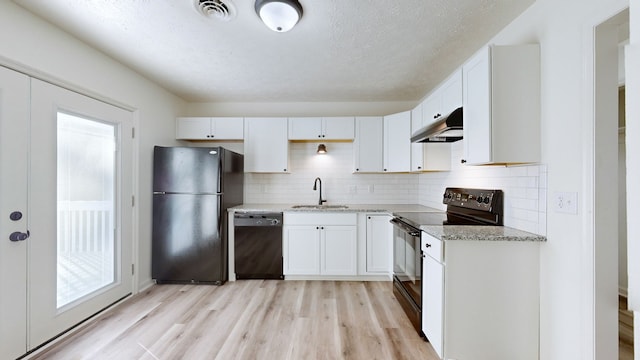 kitchen featuring sink, light wood-type flooring, white cabinetry, and black appliances