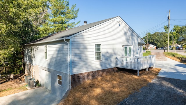 view of side of property featuring a wooden deck and cooling unit