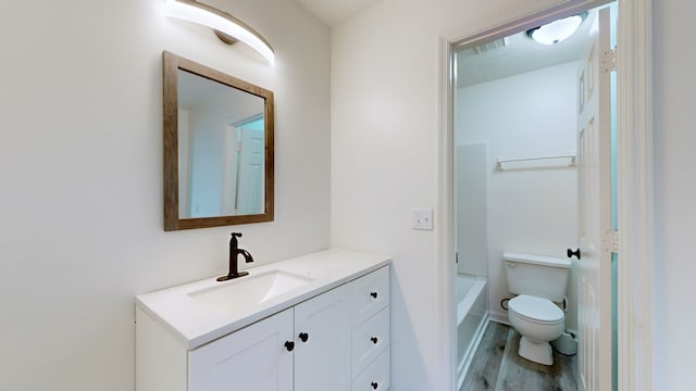 full bathroom featuring bathtub / shower combination, wood-type flooring, vanity, and toilet